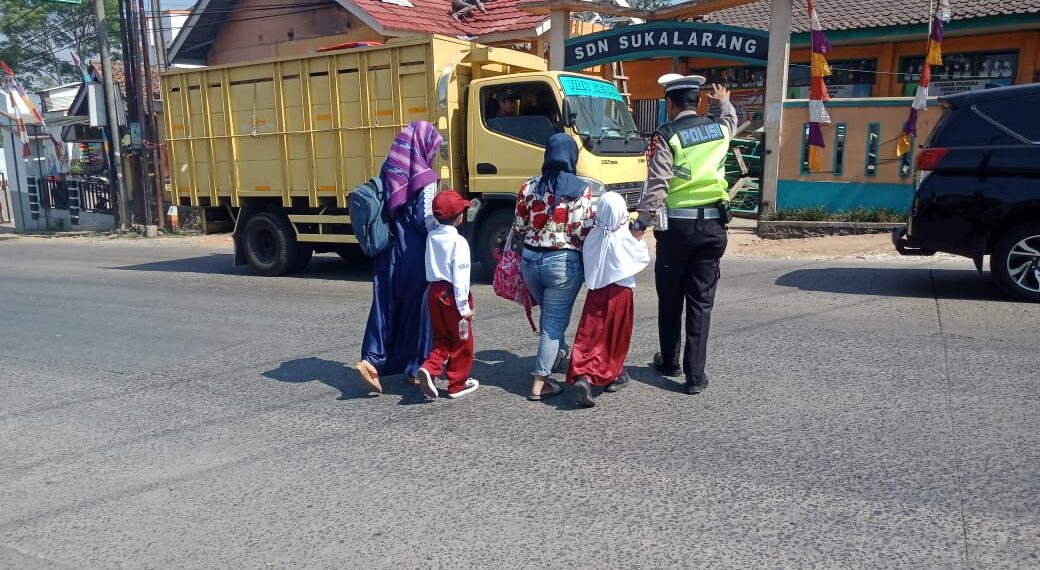 Wujud Kepedulian, Polisi Bantu Anak-Anak Sekolah Menyeberang Jalan