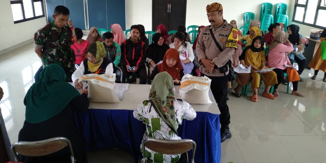Anggota Bhabinkamtibmas Kel Nyomplong melaksanakan  monitoring dan pengamanan Penyaluran Bantuan Pangan Cadangan Beras Pemerintah
